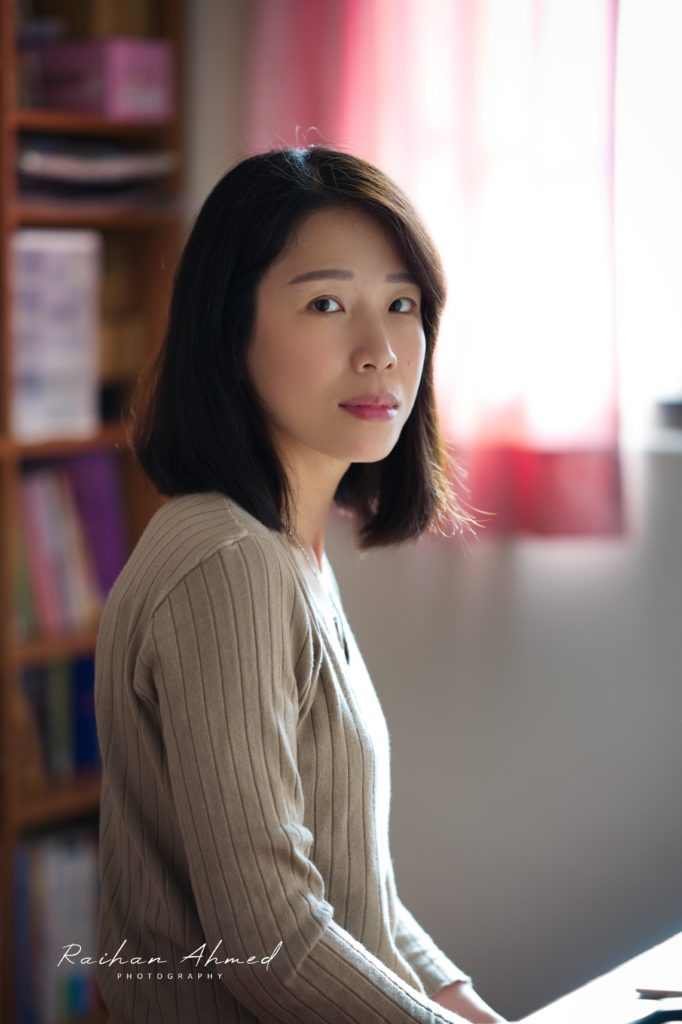 Woman sitting at desk looking into camera