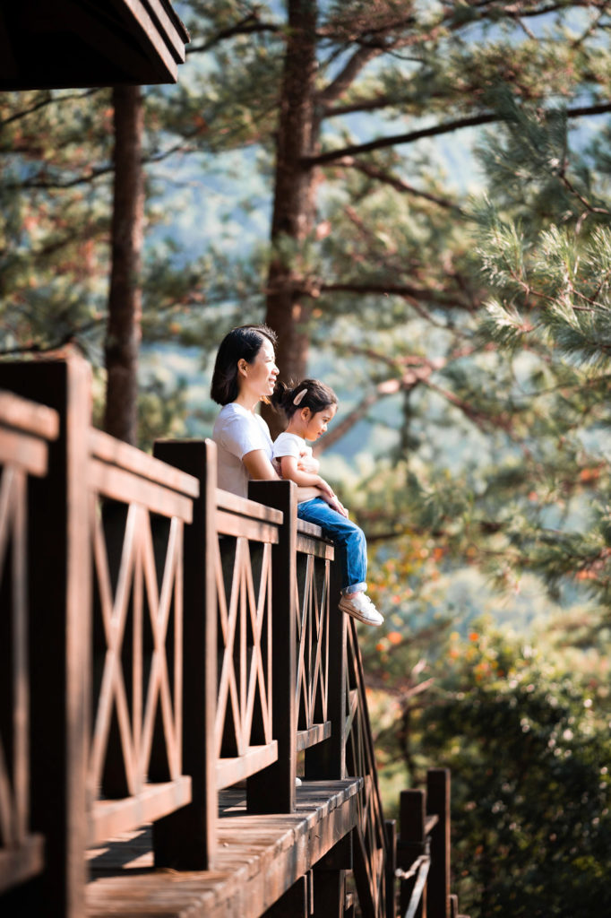 Photo of a mother and daughter in the forest.