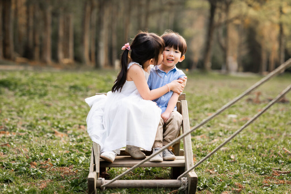 Sister giving little brother a kiss