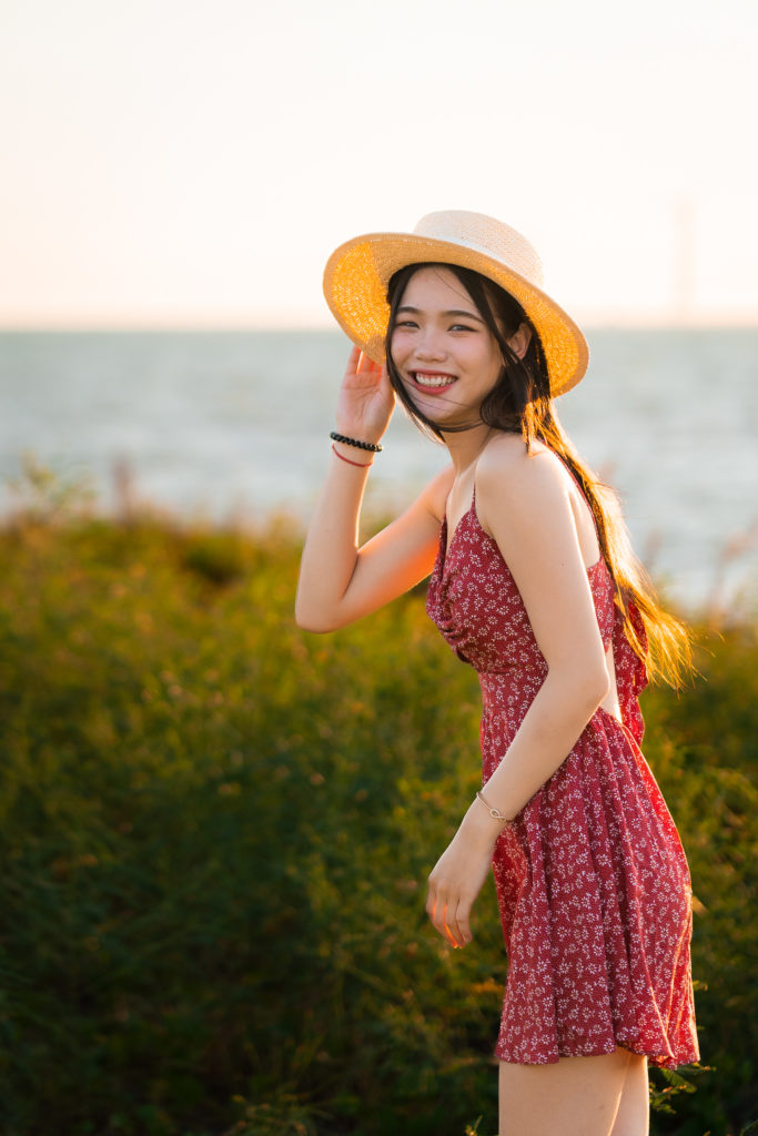 Woman wearing a hat smiling.