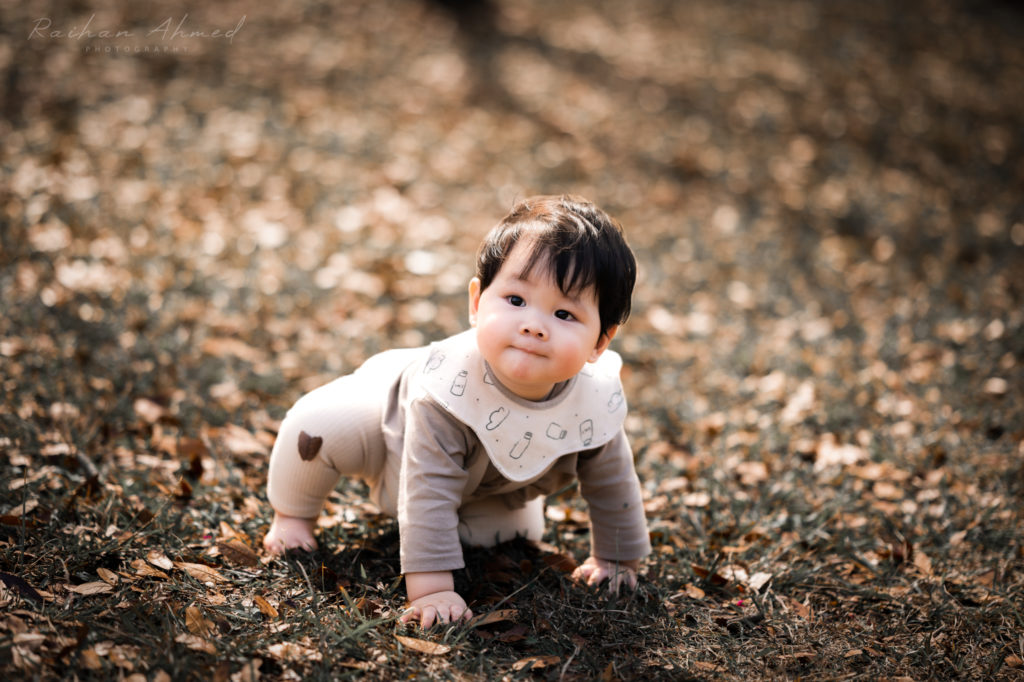Cute baby crawling on grass