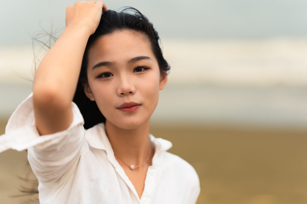 Woman putting hand through hair