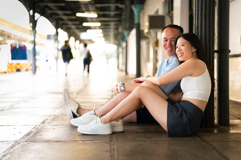 Couple sitting on train station floor