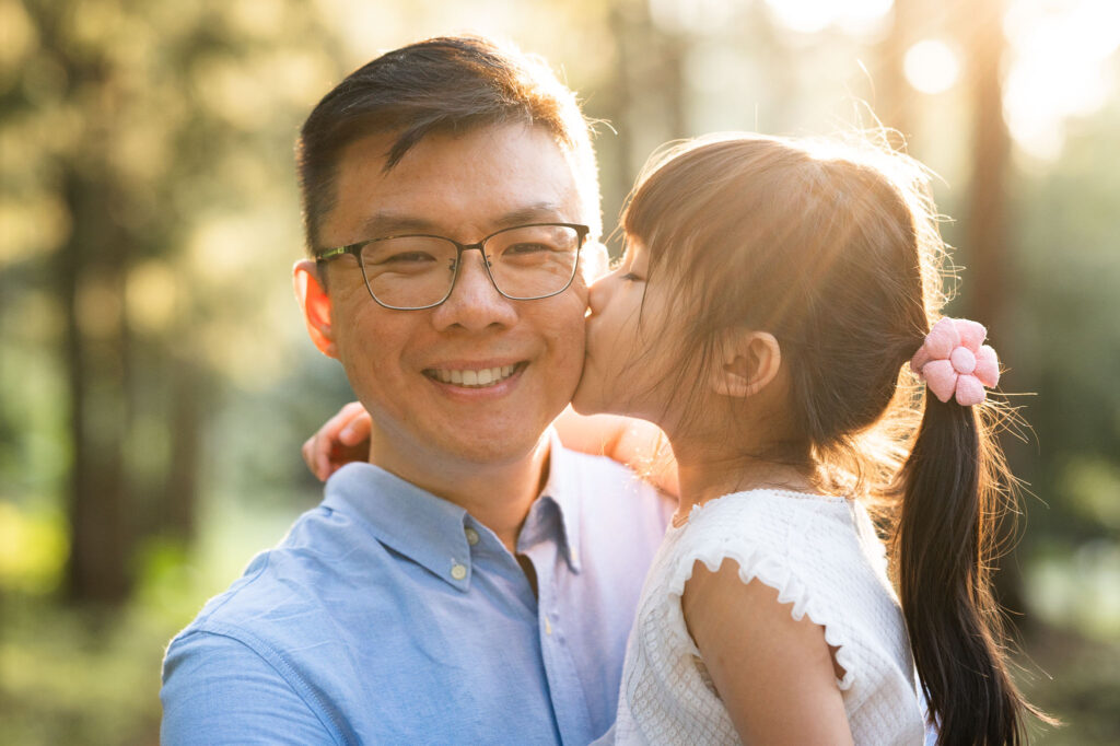 Daughter kissing father.