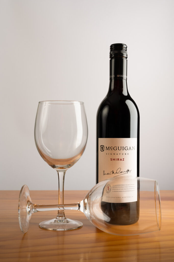 Wine bottle and 2 glasses on table